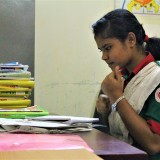 Rabia, the oldest student in Chalantika center, is going through preparatory materials for her high school admission exam.